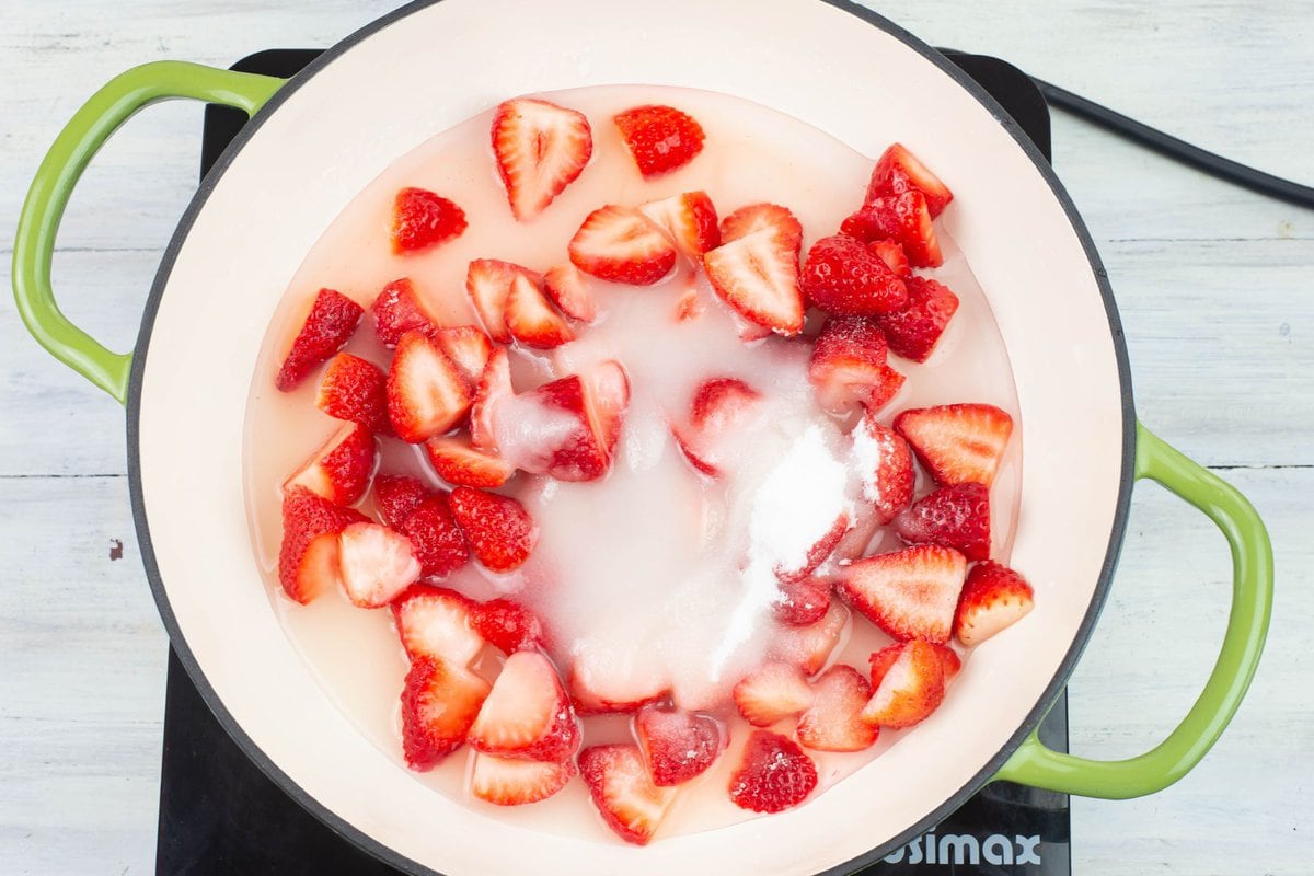 Sliced strawberries, granulated sugar, water and lemon juice in a shallow skillet.