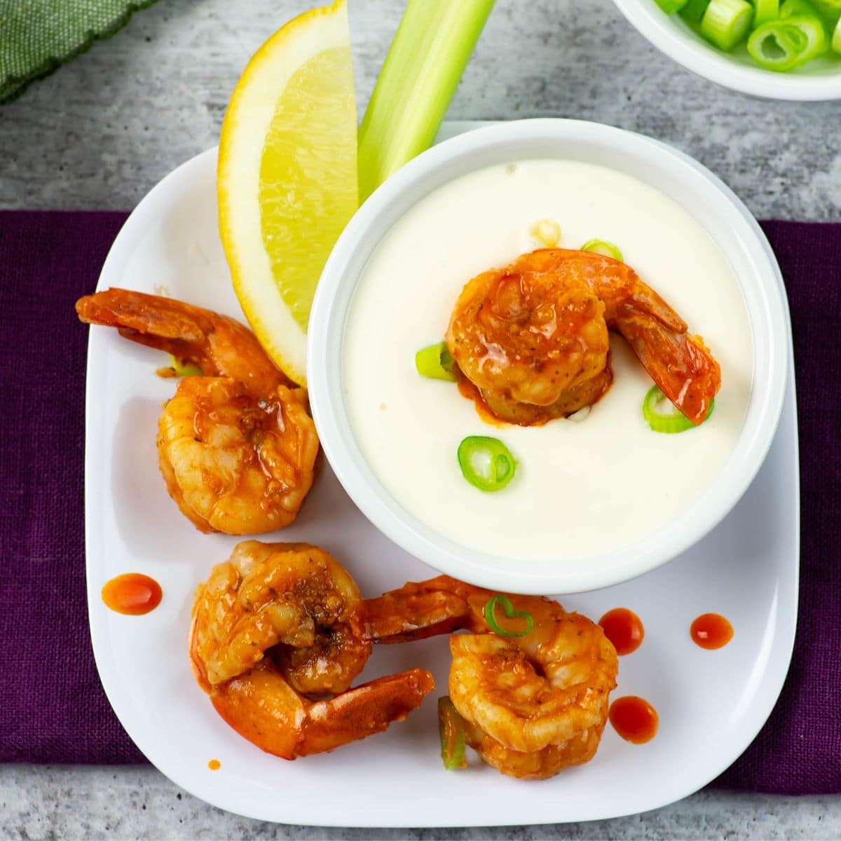 Garlic Parmesan Dressing in a small bowl served with Buffalo Shrimp.