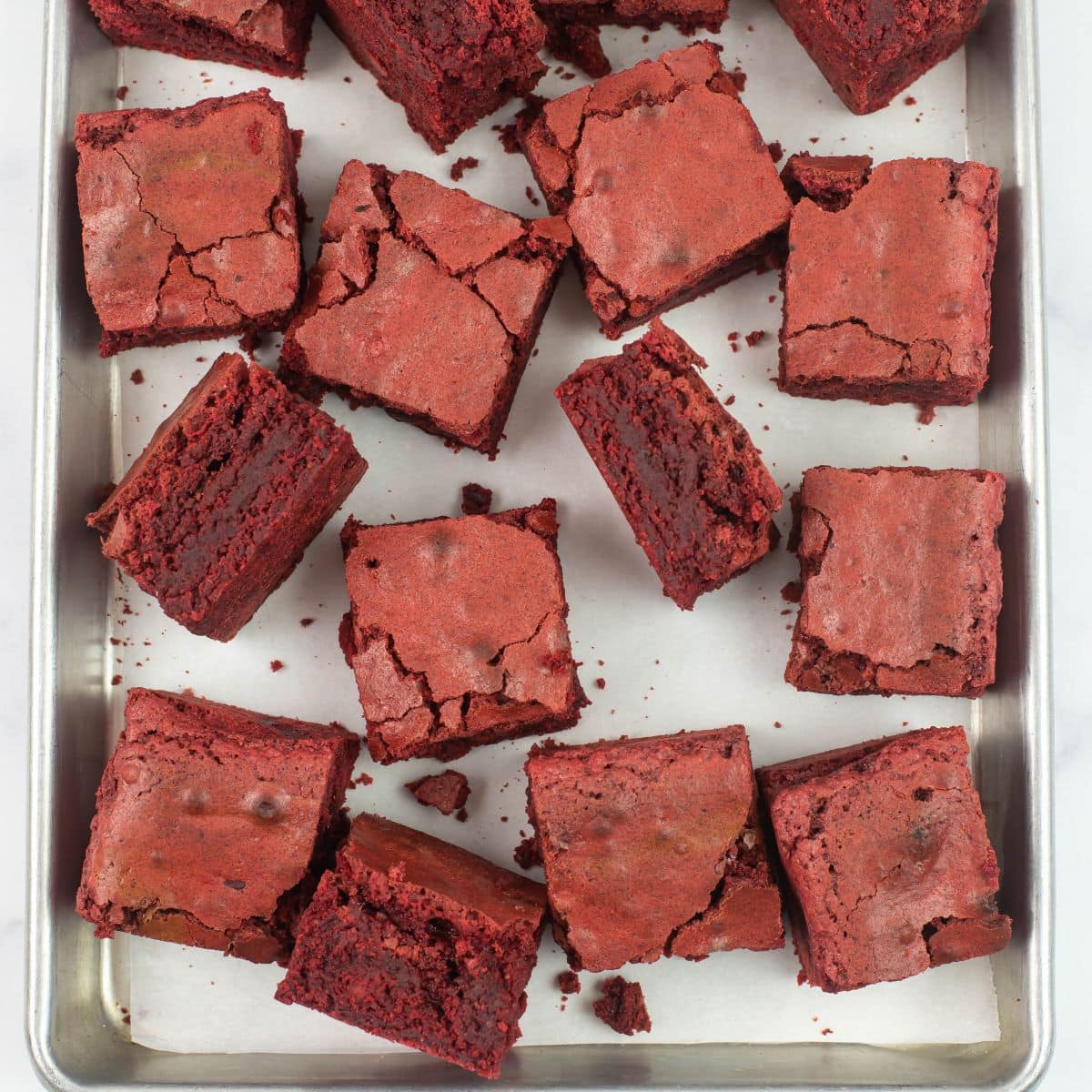 Red Velvet Brownies cut into squares on a baking sheet.
