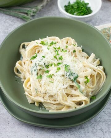 Creamy Alfredo Sauce with Cream Cheese in a green bowl.