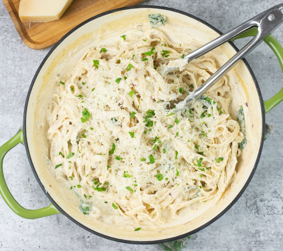 A skillet filled with homemade alfredo sauce made with cream cheese.