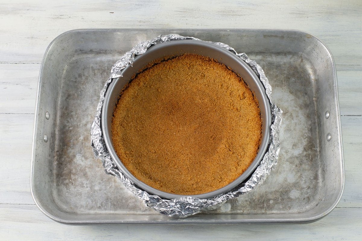 Prepped cheesecake pan inside a large roasting pan.