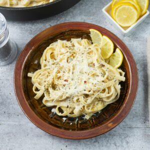A serving of Lemon Garlic Alfredo Sauce with pasta in a bowl.