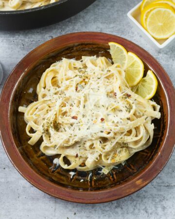 A serving of Lemon Garlic Alfredo Sauce with pasta in a bowl.