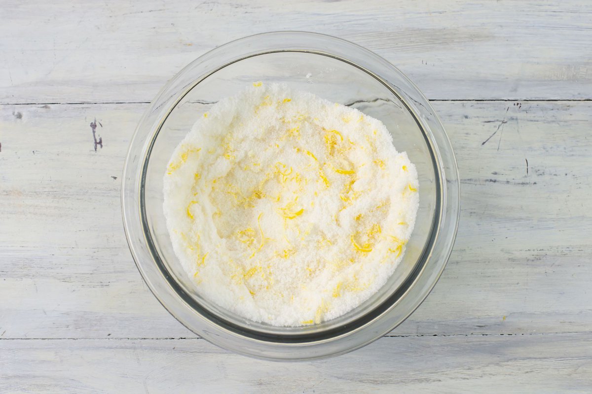 Lemon zest and granulated sugar mixed together in a bowl.