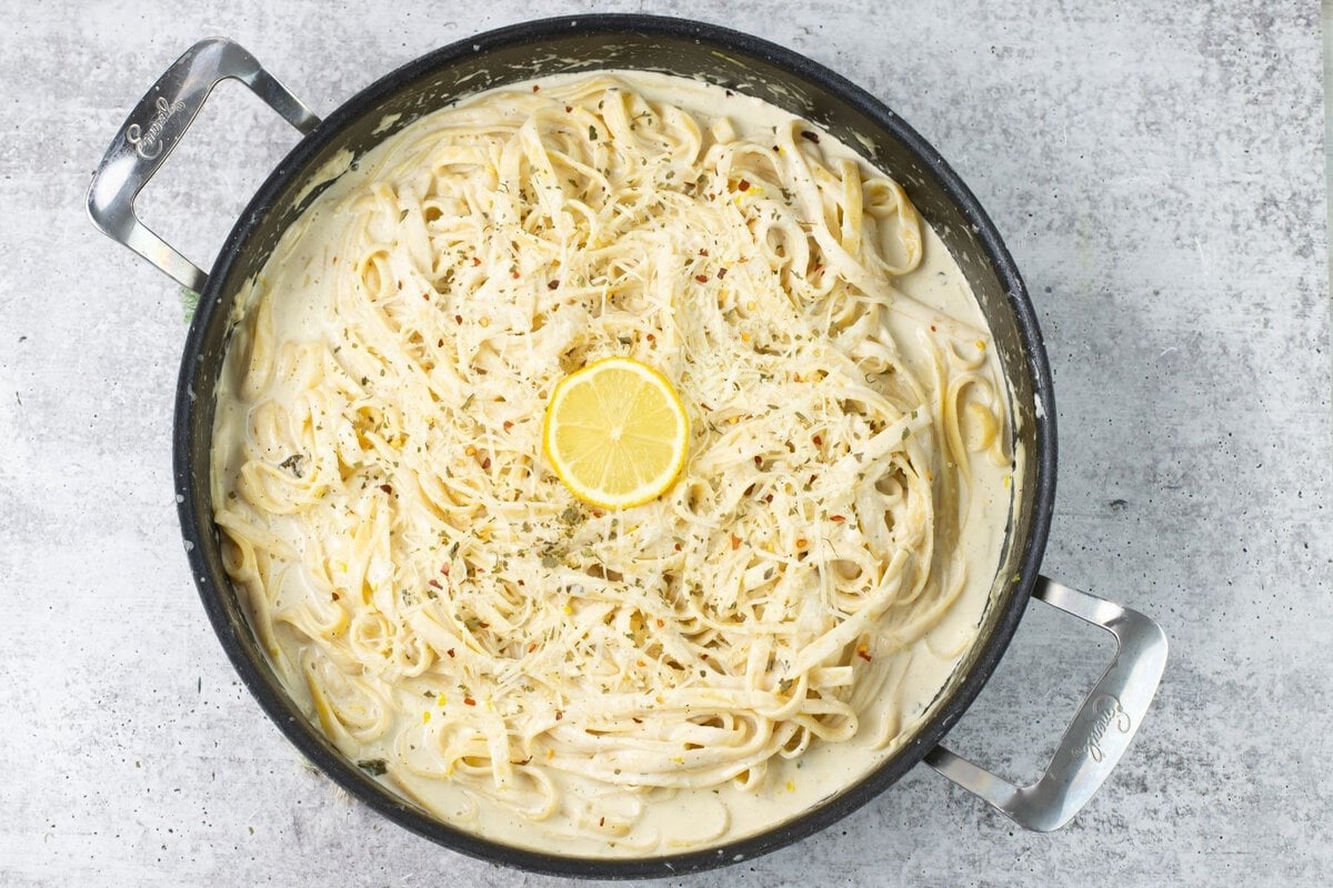 Lemon Garlic Alfredo Sauce served over Fettuccine garnished with sliced lemon, dried parsley and red pepper flakes.