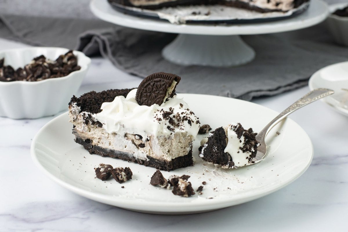 Sliced OREO cookie cheesecake with a forkful of a bite.