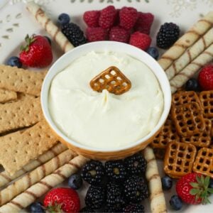 Cheesecake Dip served with fruit, pretzels and cookies in a dip tray.