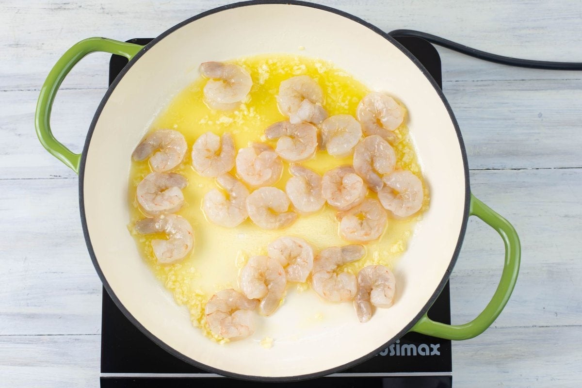 Cooking shrimp in butter, olive oil and minced garlic for scampi.