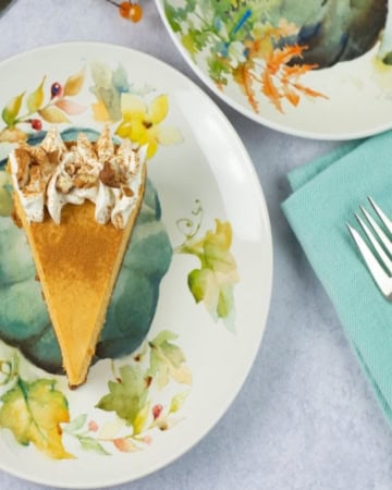 Serving a wedge of pumpkin cheesecake on a plate.