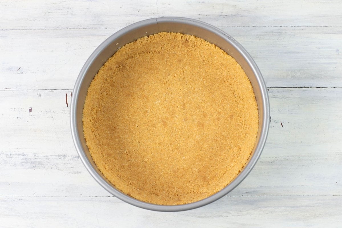 Ladyfinger cookie cheesecake crust pressed into a 9-inch springform pan.
