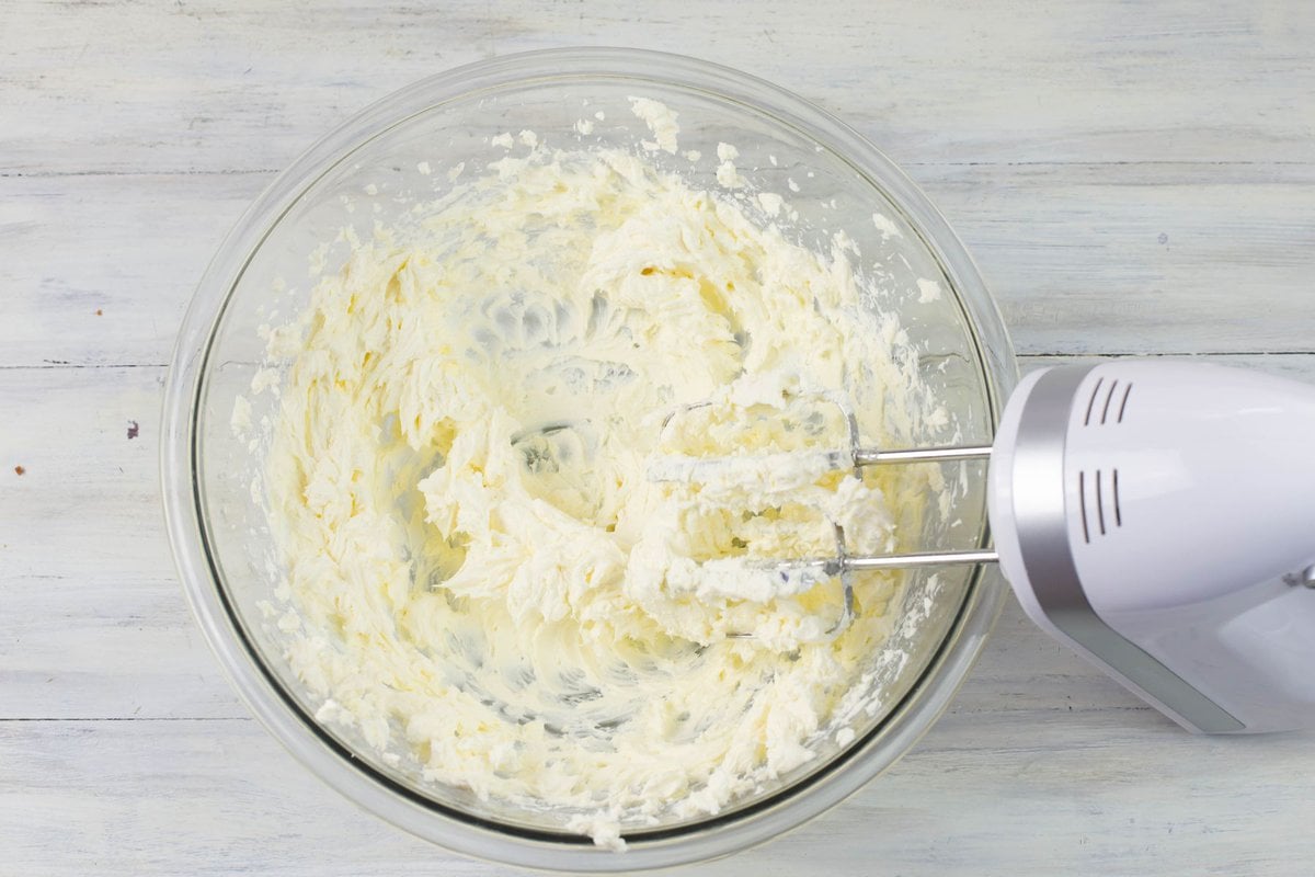Softened and beaten cream cheese in a mixing bowl.
