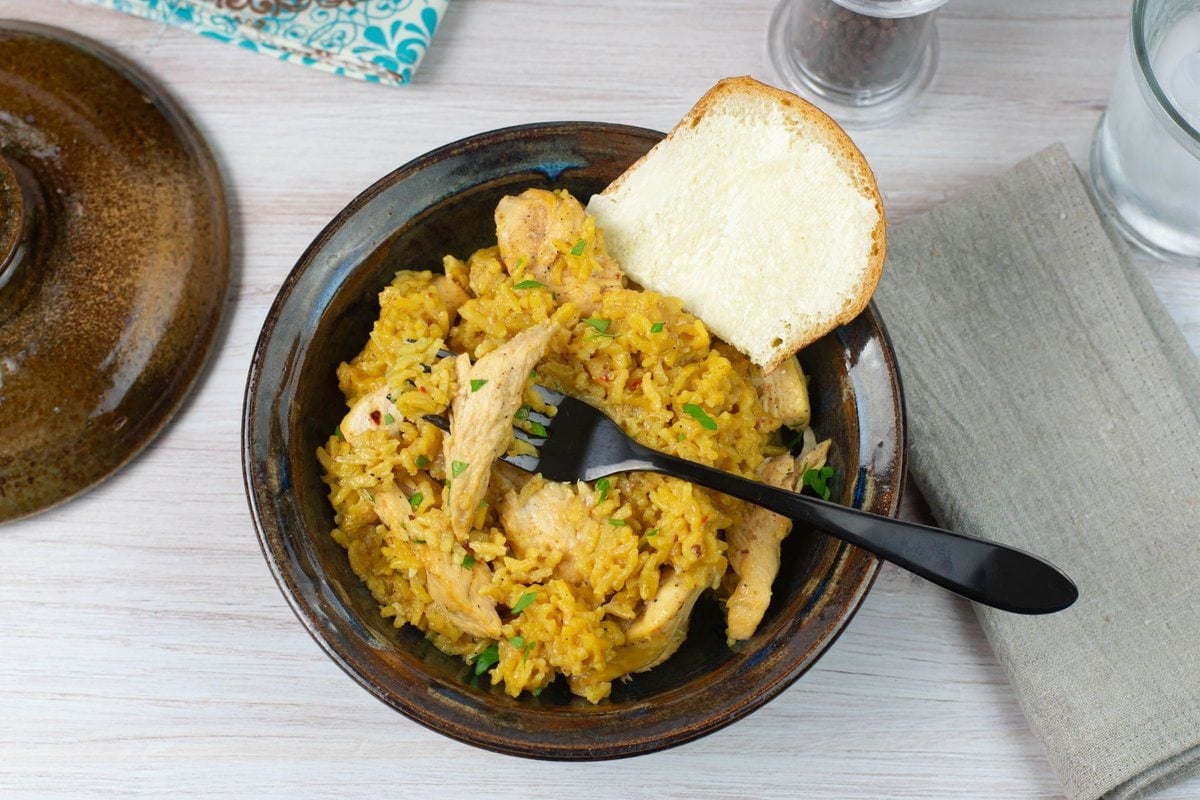 Tender chicken cooked in yellow rice.