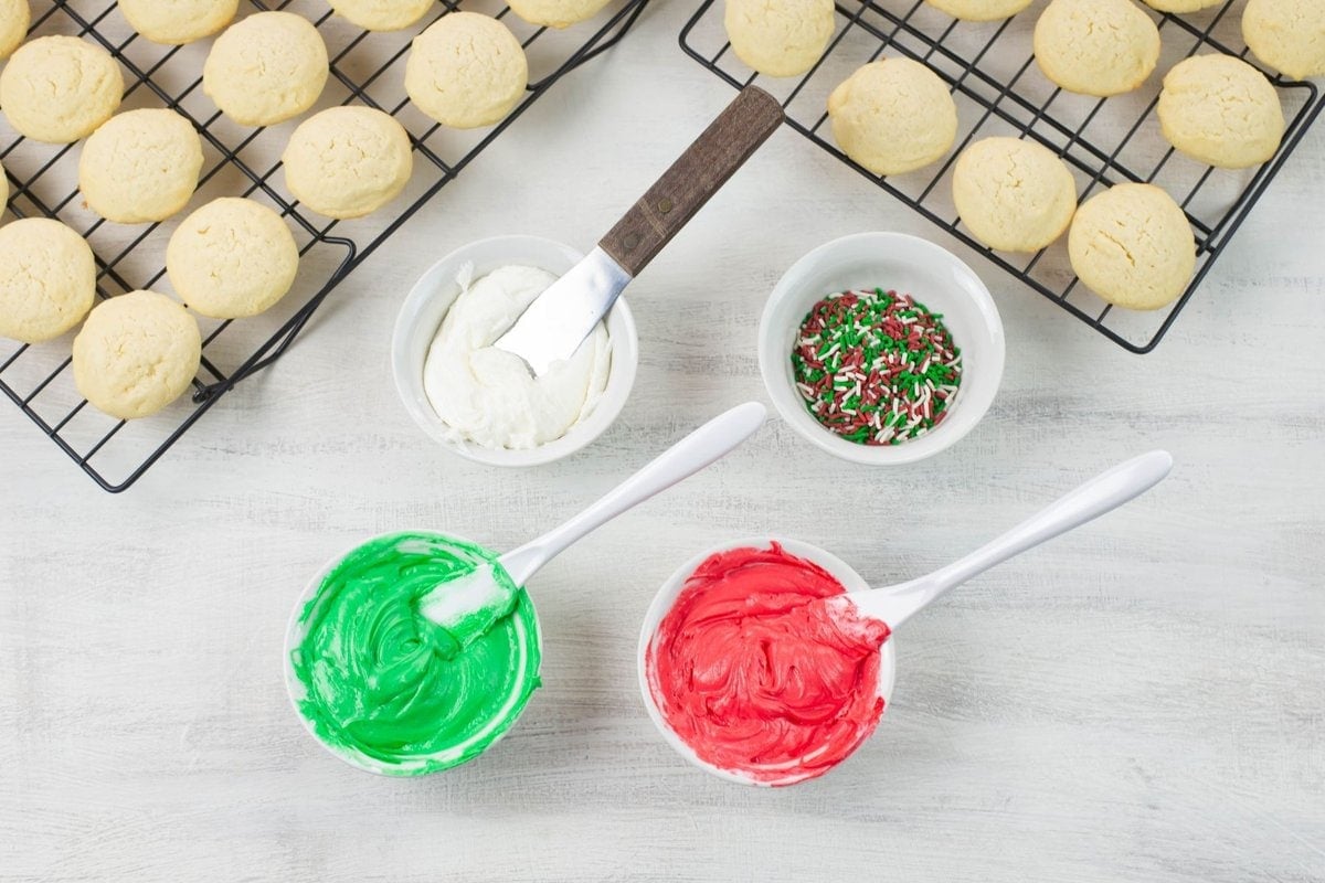 Frosting divided into three small bowls and colored with gel food coloring.