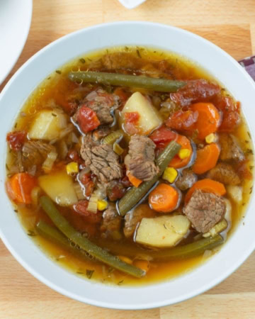 Instant Pot Beef Vegetable Soup in a bowl served with soup crackers.