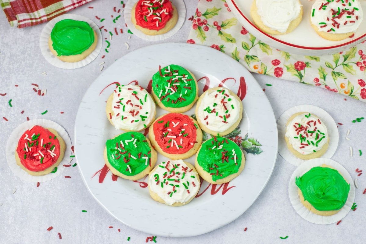 Red, green and white frosted Christmas sugar cookies on a holiday plate.