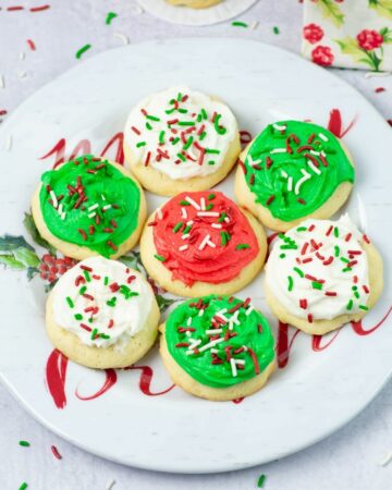 soft frosted Christmas cookies on a holiday plate.