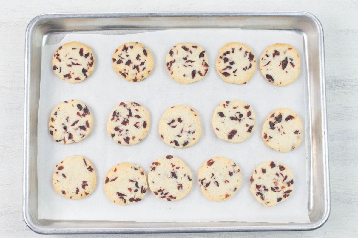 Baked cranberry Christmas cookies on a baking sheet.