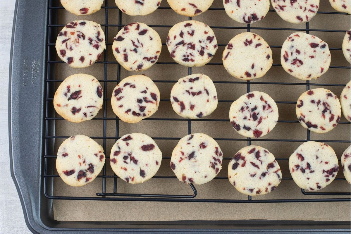 Baked cranberry shortbread cookies cooling on a wire rack.