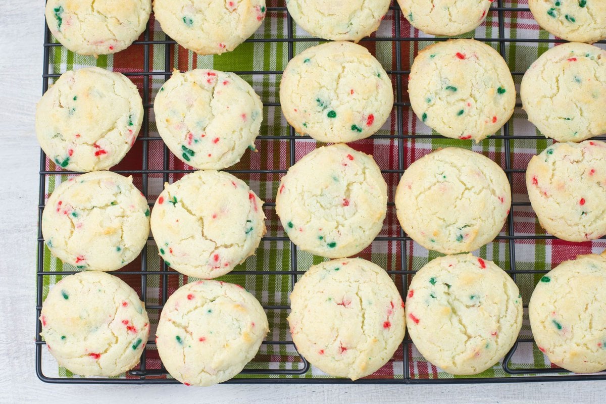 Funfetti Christmas cookies cooling on a wire rack.