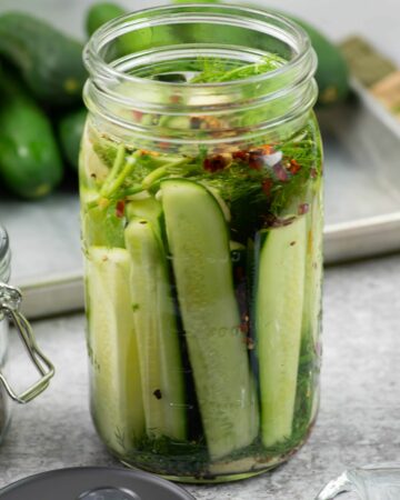 Fermenting pickles in a wide mouth mason jar.
