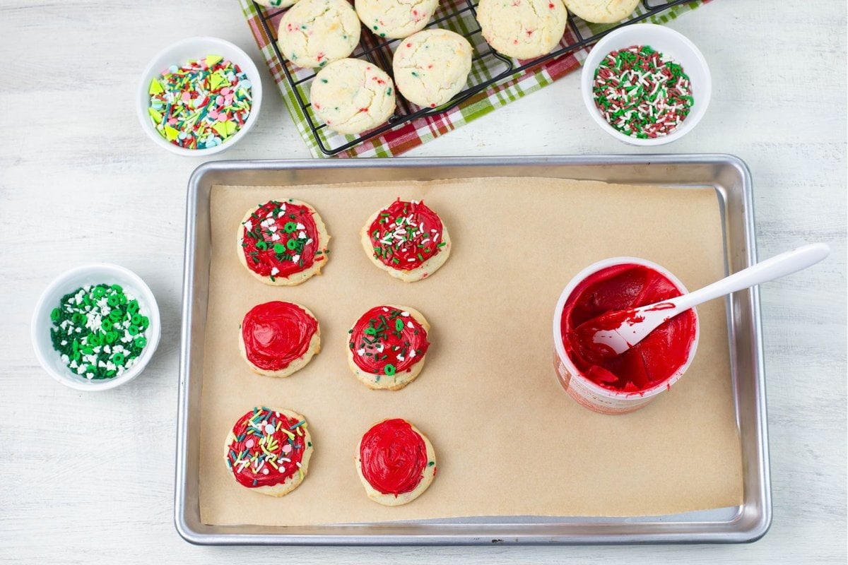 Frosting and decorating Funfetti Christmas Cookies.
