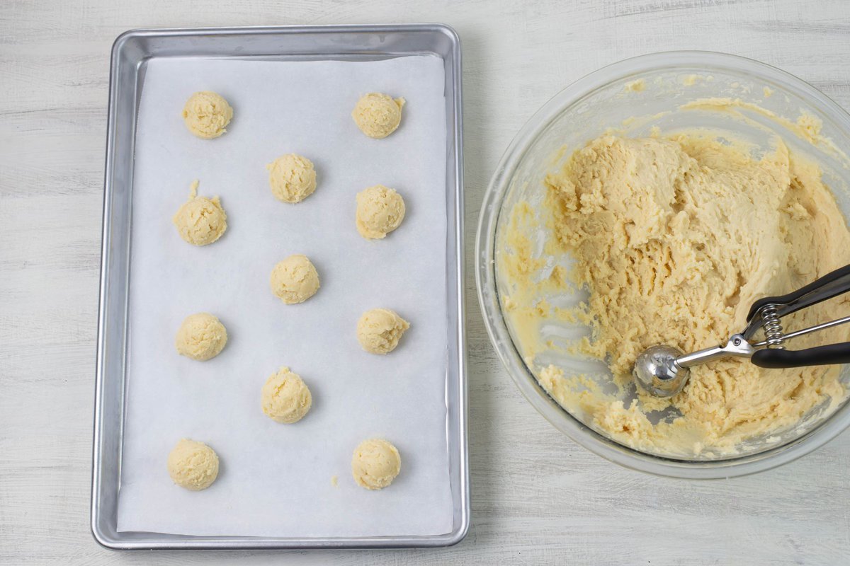 Italian Christmas cookie dough balls on a baking sheet.