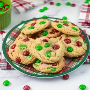 M & M Christmas Cookies stacked on a holiday plate.