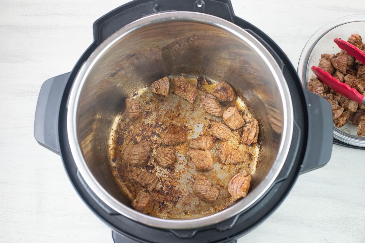 Browning bite size stew meat in Instant Pot.