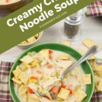 Creamy Chicken Noodle Soup served in a bowl with crackers.