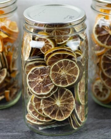 Dehydrated Lime Slices in quart mason jars.