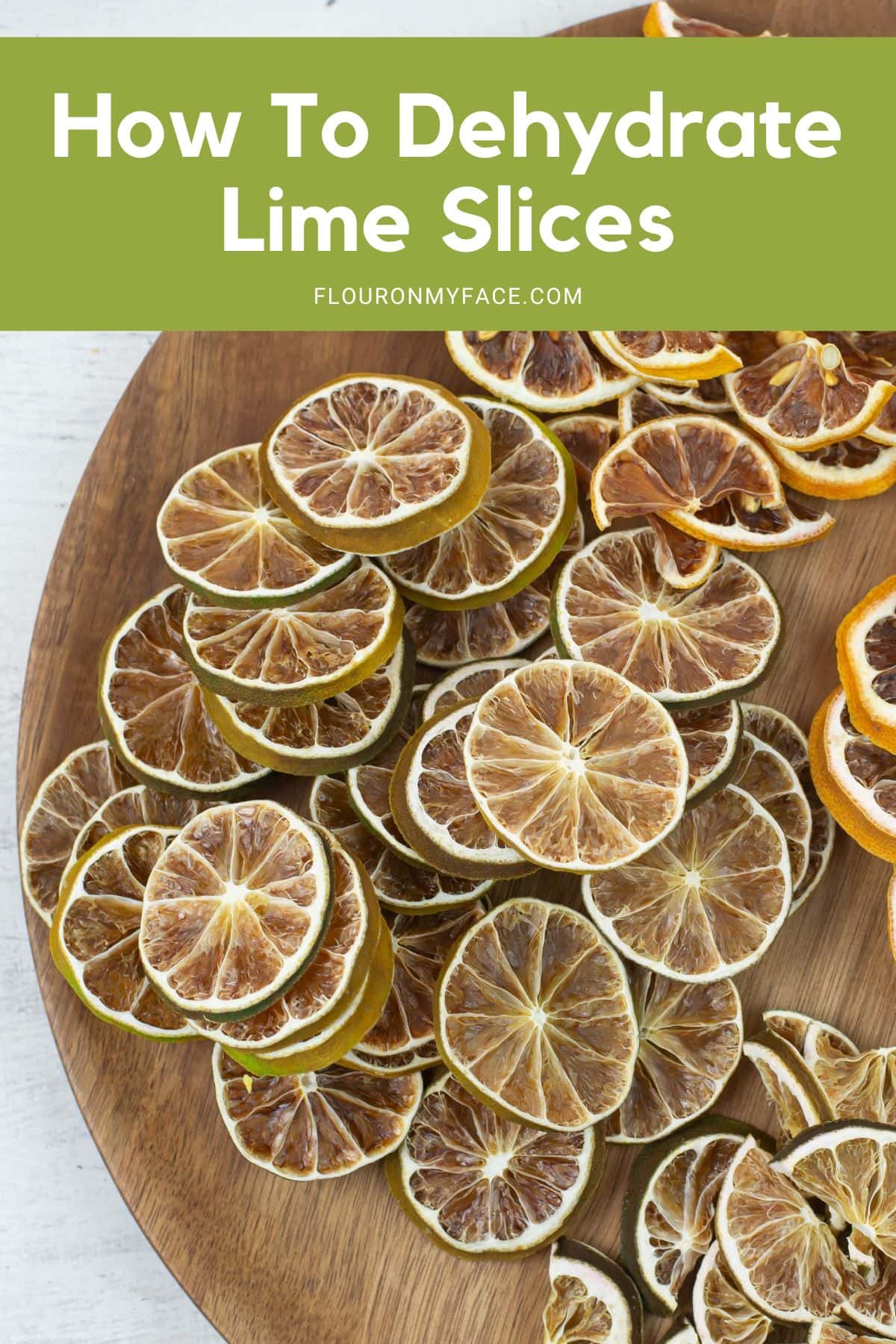 Dehydrated lime slices on a round wooden board.