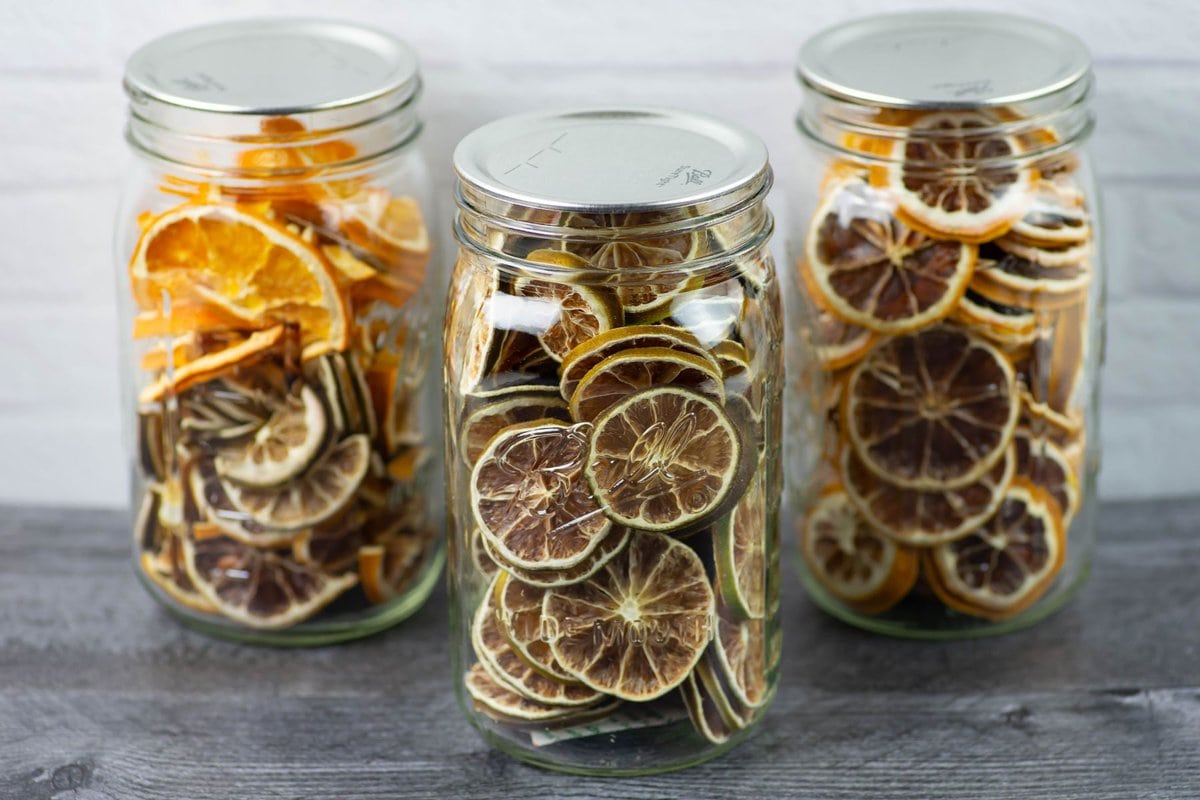 3 jars of Dehydrated citrus slices stored in vacuum sealed mason jars.