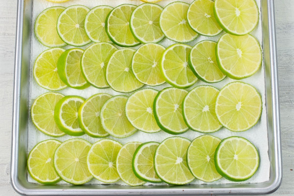 Thin slices of limes on a baking sheet.