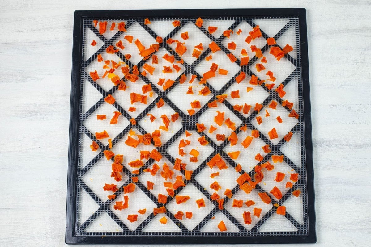 Diced dehydrated butternut squash on the dehydrator tray.