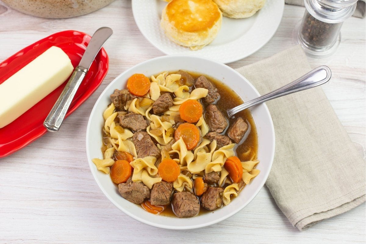 Beef and noodle soup served with homemade biscuits.