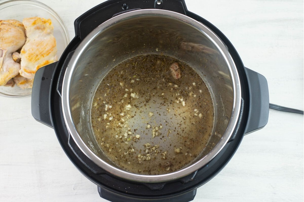 Mixing the garlic and spices together in the pot.