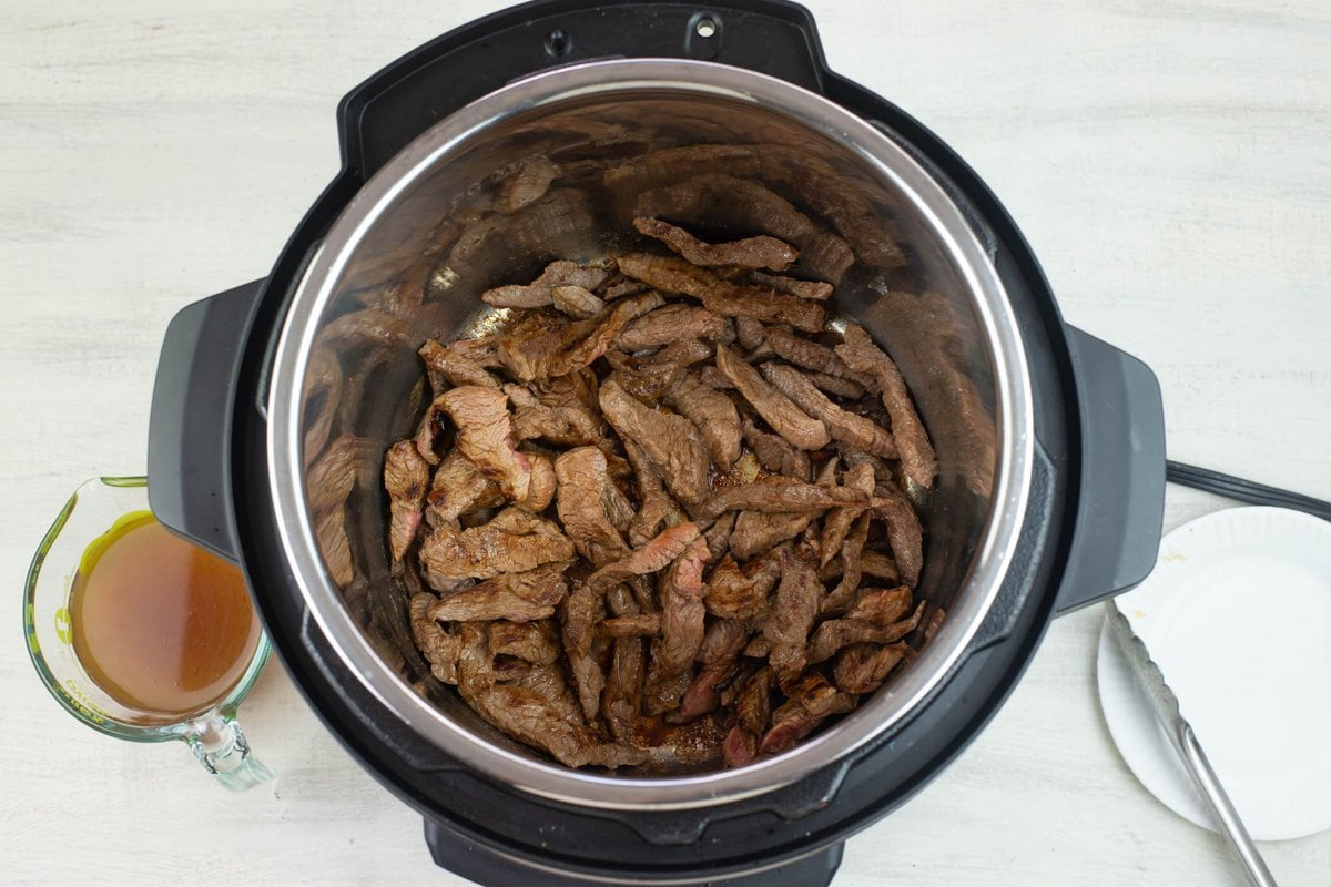 Thin sliced beef browning in the Instant Pot.