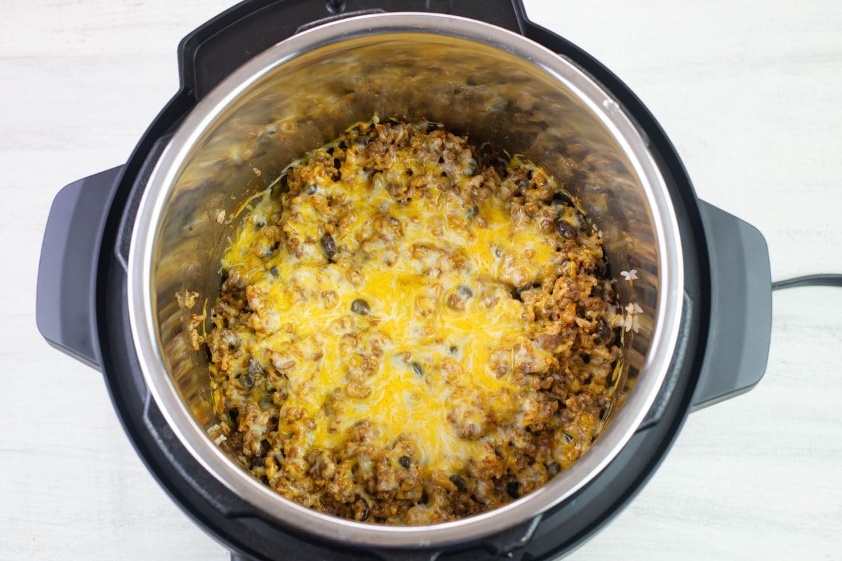 Melted cheese on top of the ground beef and rice in the Instant Pot.