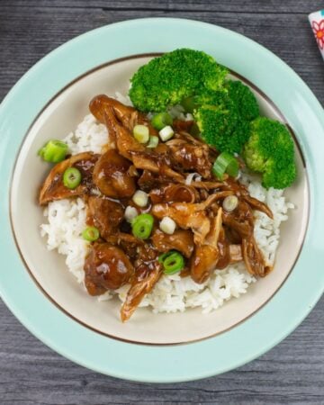 Single serving of Instant Pot Chicken Adobo over rice with steamed broccoli.