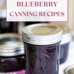 Long vertical image of blueberry jam in canning jars.
