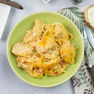 Pasta bowl filled with Chicken Spaghetti with Rotel served with bread.