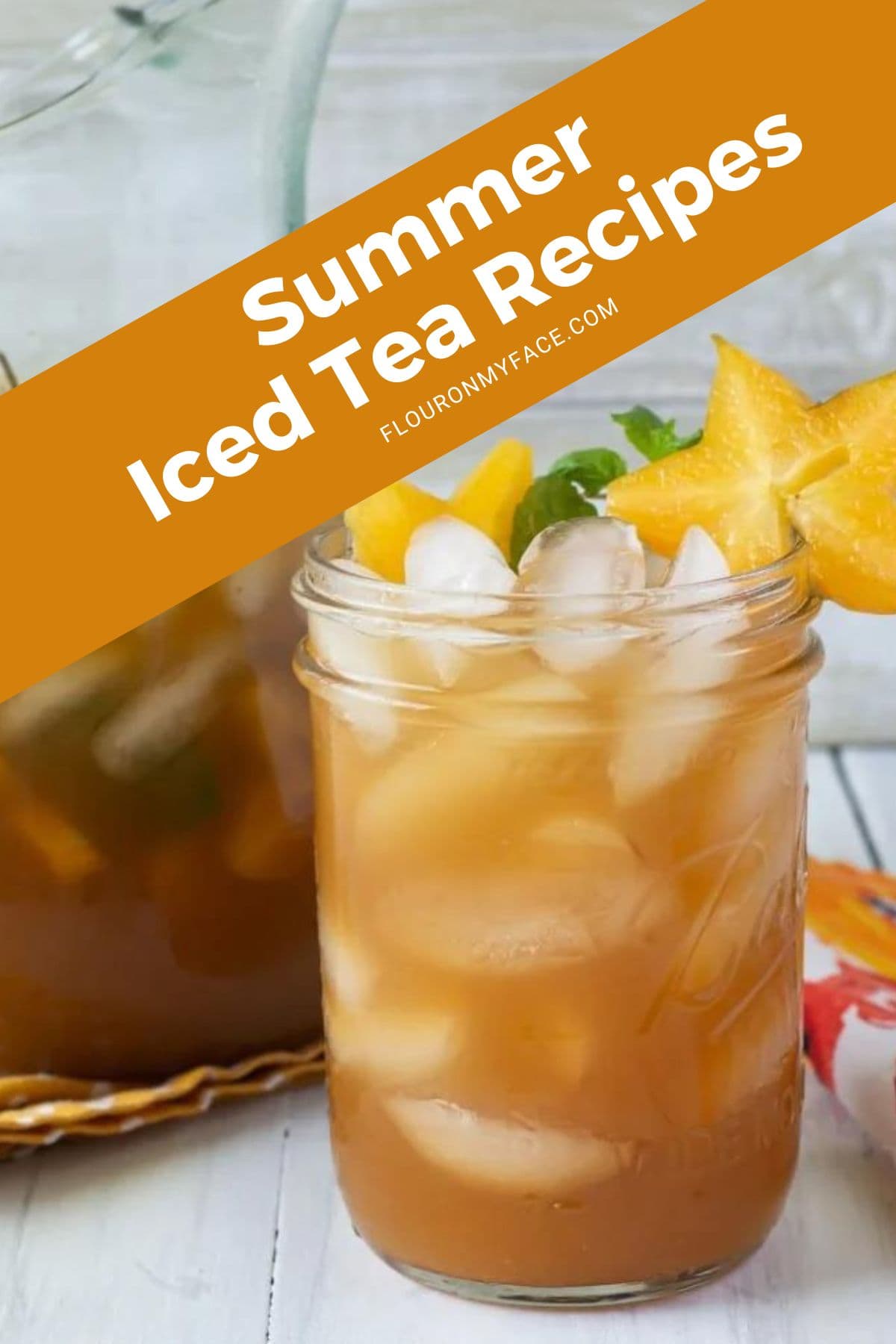 Image of a mason jar filled with carambola iced tea with a pitcher in the background.