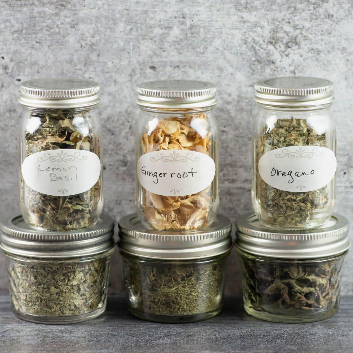 6 spice jars filled with dried herbs.