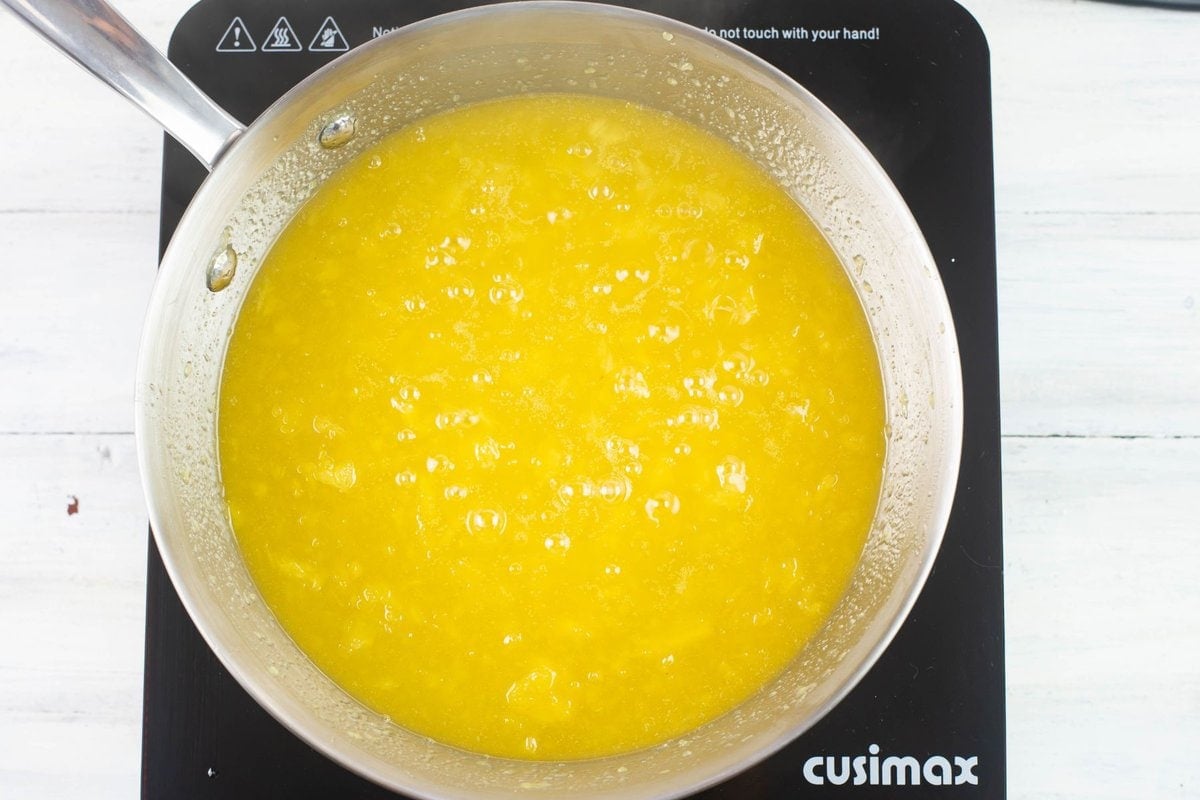 Pineapple topping boiling in a sauce pan.