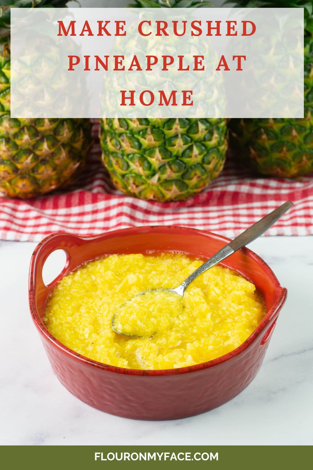 Red bowl filled with homemade crushed pineapple with pineapples in background.
