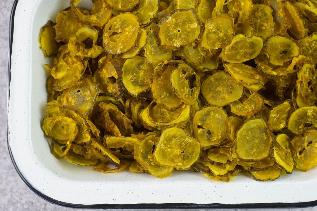 Dried pickle snacks in a square bowl.