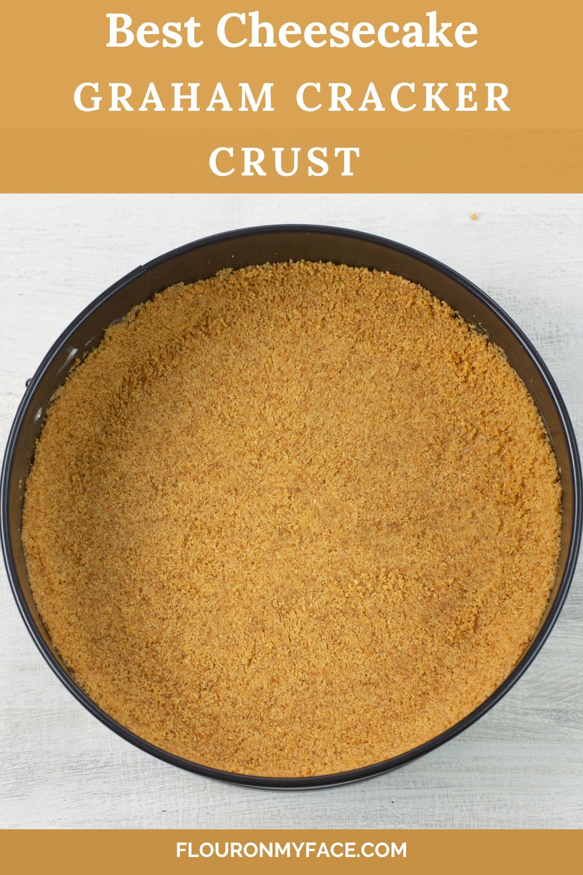 Large verticle image of a cheesecake graham cracker crust in a baking pan.