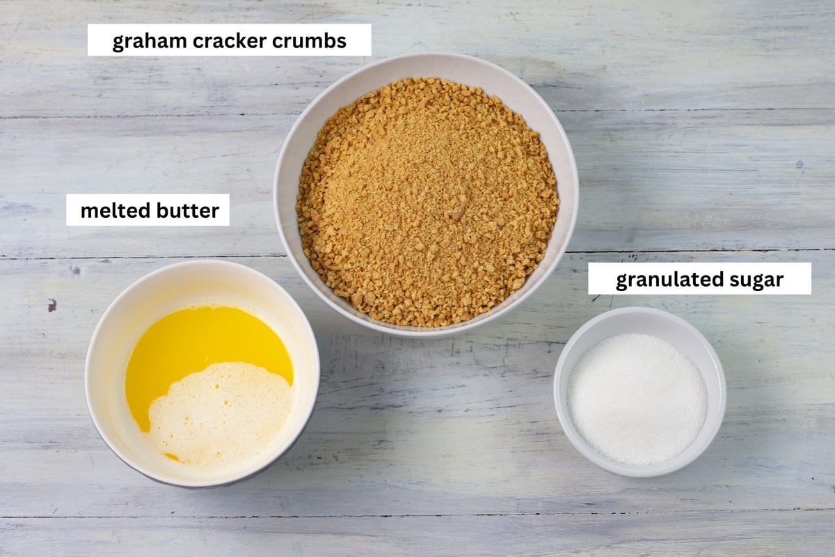 Bowl with graham cracker crumbs, melted butter and white sugar.