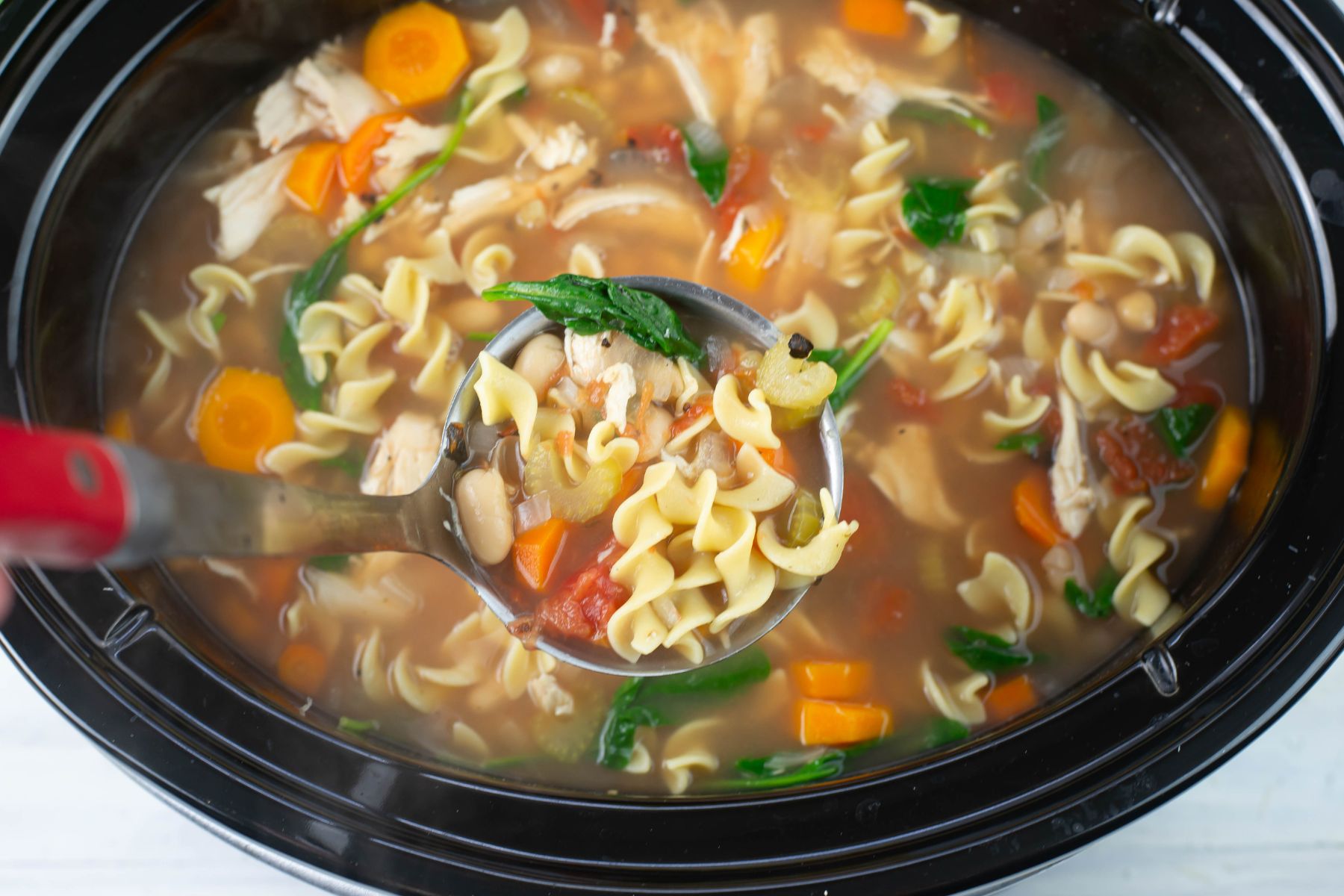 Slow cooked Tuscan Chicken soup in a crock pot.